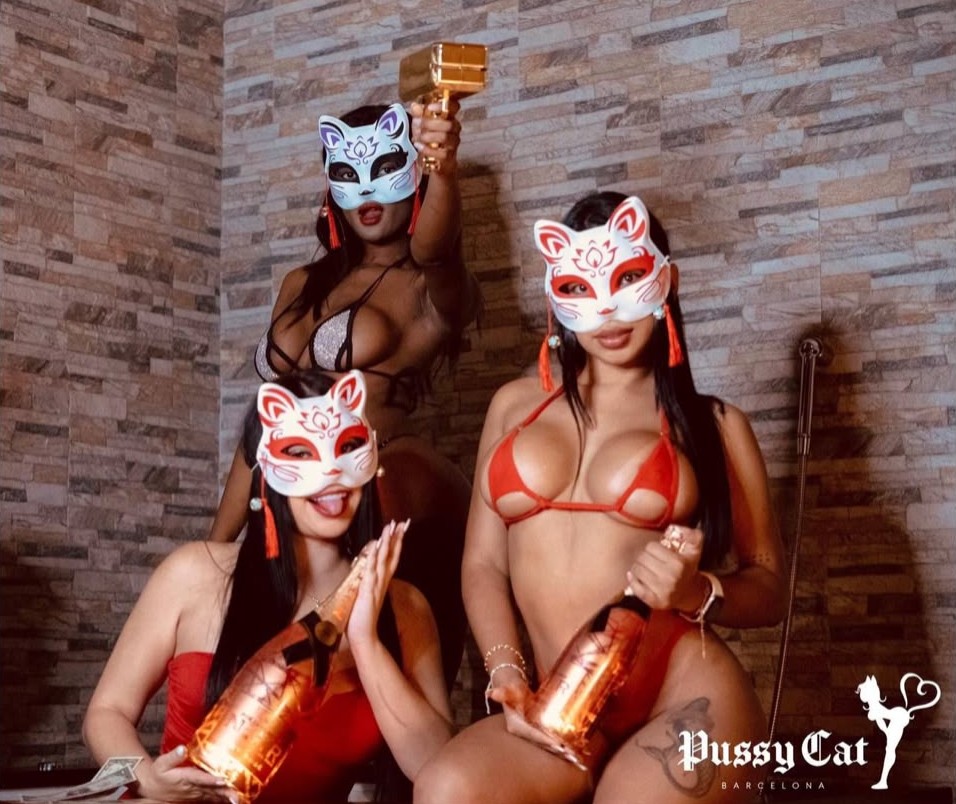Dancers with signature cat masks and champagne